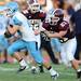 Skyline senior Jake Hirschl runs the ball past Dexter senior Jeff Baldus  during the first half at Dexter on Friday night.